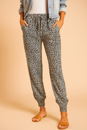 Leopard print jogger pants with an elastic waistband and gathered cuffs, designed in a relaxed silhouette for casual comfort and effortless style.