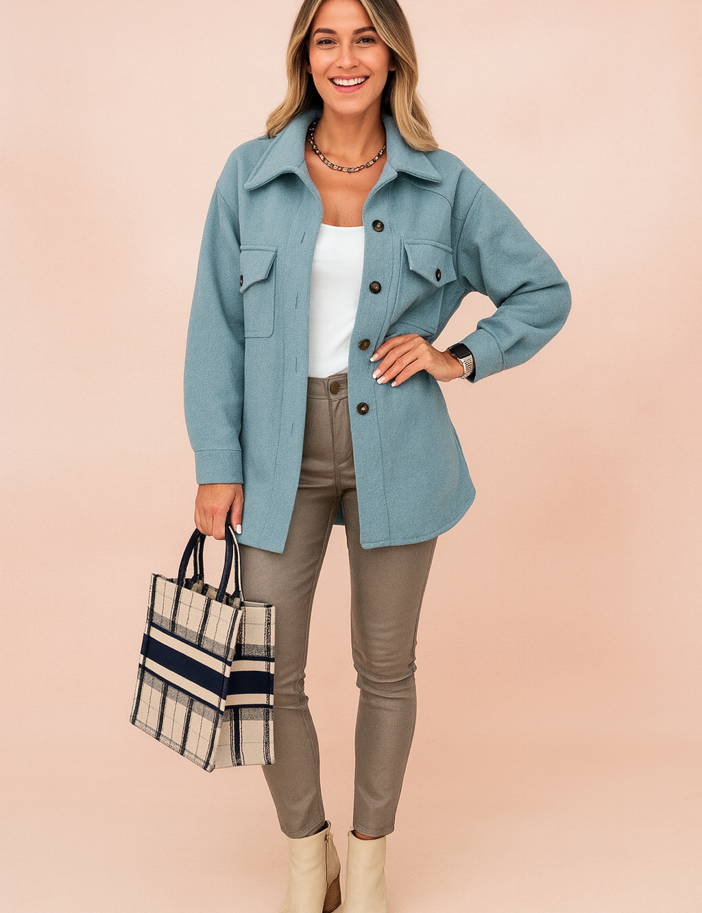 Light blue button-up wool jacket with flap pockets, paired with a white fitted tank top, taupe slim-fit leather pants, plaid tote bag, and cream ankle boots for a chic casual look.