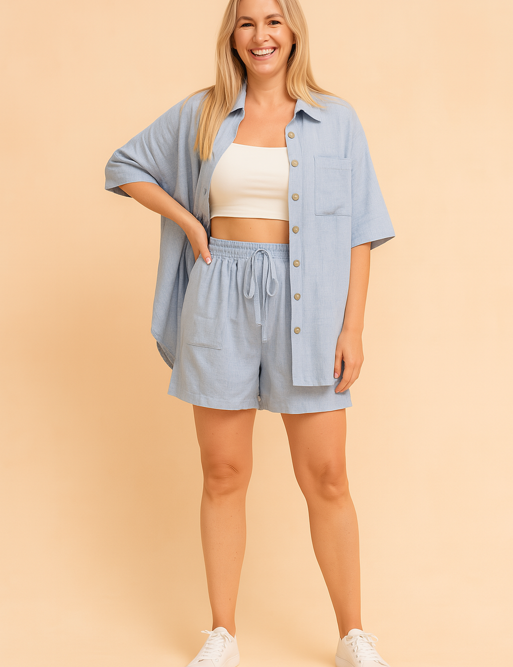 Relaxed-fit light blue two-piece coords featuring a short-sleeve button-down shirt with a chest pocket and matching high-waisted drawstring shorts; both pieces crafted from a smooth woven fabric with a consistent soft texture and subtle heathered finish, accurately reflecting the original pattern and shade.