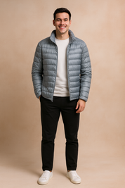 Light gray puffer jacket with horizontal quilted design and front zipper, styled with a white t-shirt, black trousers, and white sneakers.