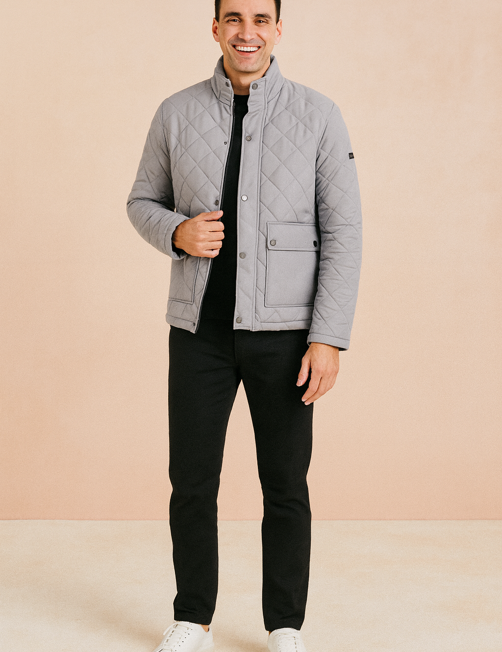 Light gray diamond-quilted jacket with stand-up collar, flap pocket, and snap-button closure, paired with black trousers and white sneakers.