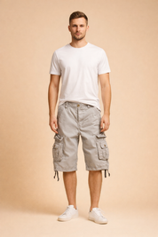 Light grey cotton cargo shorts with multi-pocket utility design, button-flap side pockets, reinforced stitching, adjustable hem drawstrings, paired with a plain white short-sleeve crew-neck T-shirt and clean white low-top sneakers.