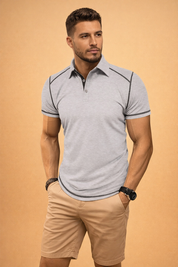 Light grey heather short-sleeve polo shirt with a two-button placket, contrast dark stitching along the shoulders and sleeve hems, paired with beige tailored chino shorts with a clean, structured finish.