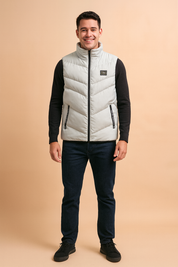 Light grey sleeveless puffer vest with black zipper details, lightweight quilted design, and modern stand-up collar for casual winter wear.