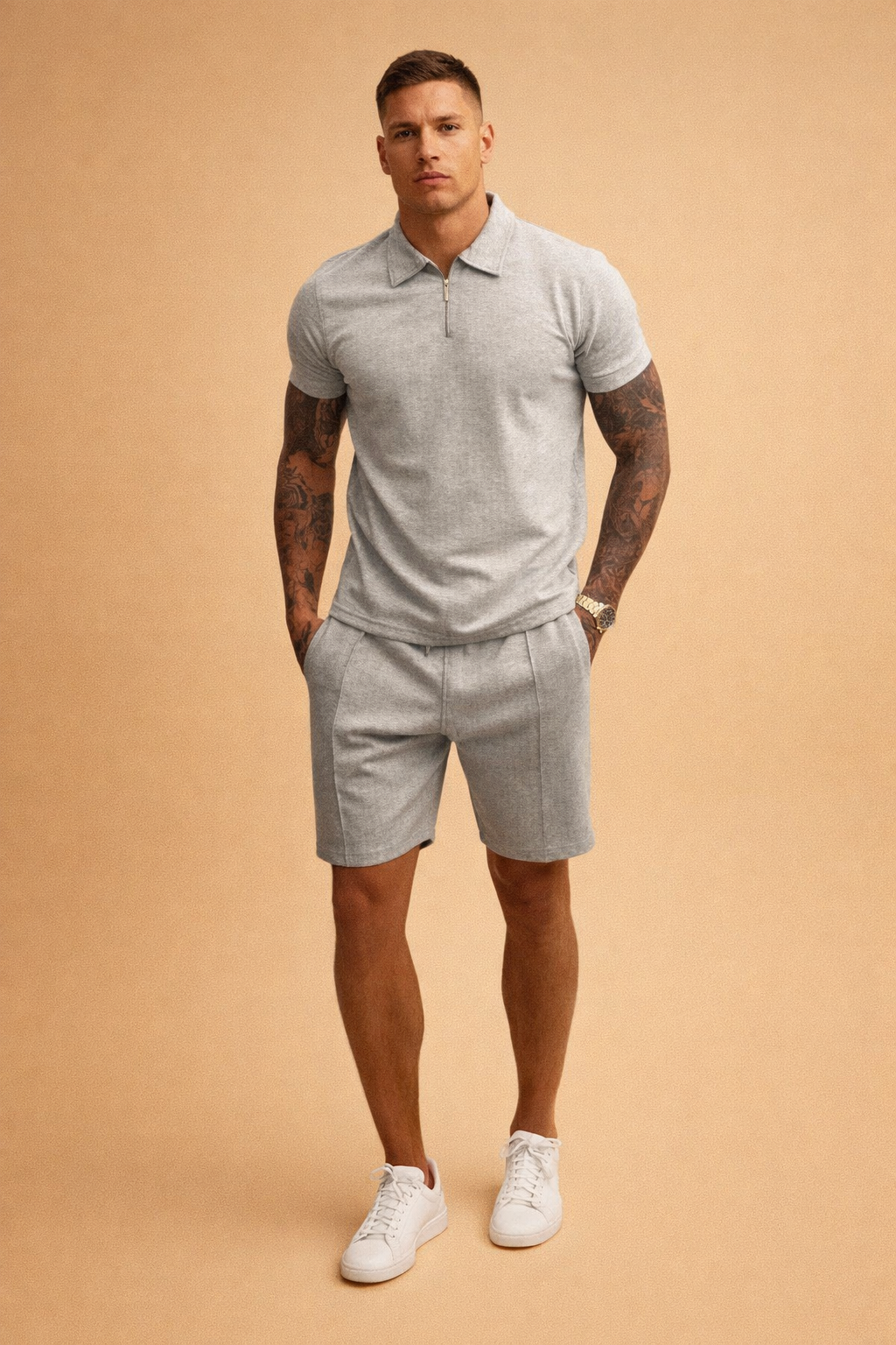 Light grey short-sleeve zip polo shirt in smooth heathered knit fabric paired with matching tailored shorts, featuring a clean minimalist cut, precise seam lines, and a coordinated solid grey tone for a refined modern menswear set