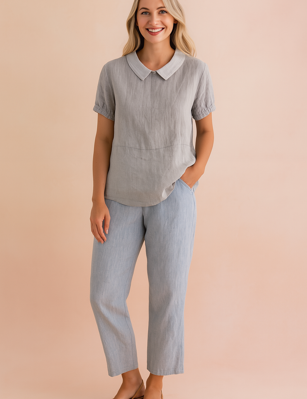 Light gray short-sleeve linen blouse with a white Peter Pan collar and gathered cuffs, paired with straight-cut light blue linen trousers and tan open-toe flats.