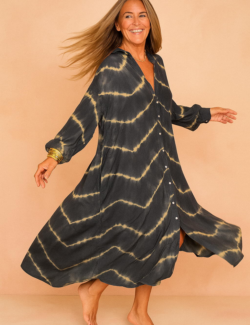 Confident European woman in a loose black and beige tie-dye maxi shirt dress with buttons.