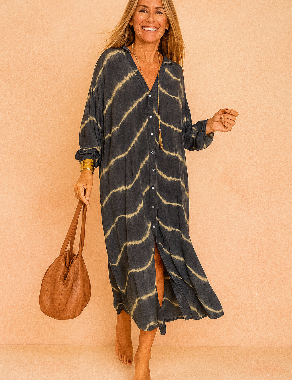 Confident European woman in a loose black and beige tie-dye maxi shirt dress with buttons.