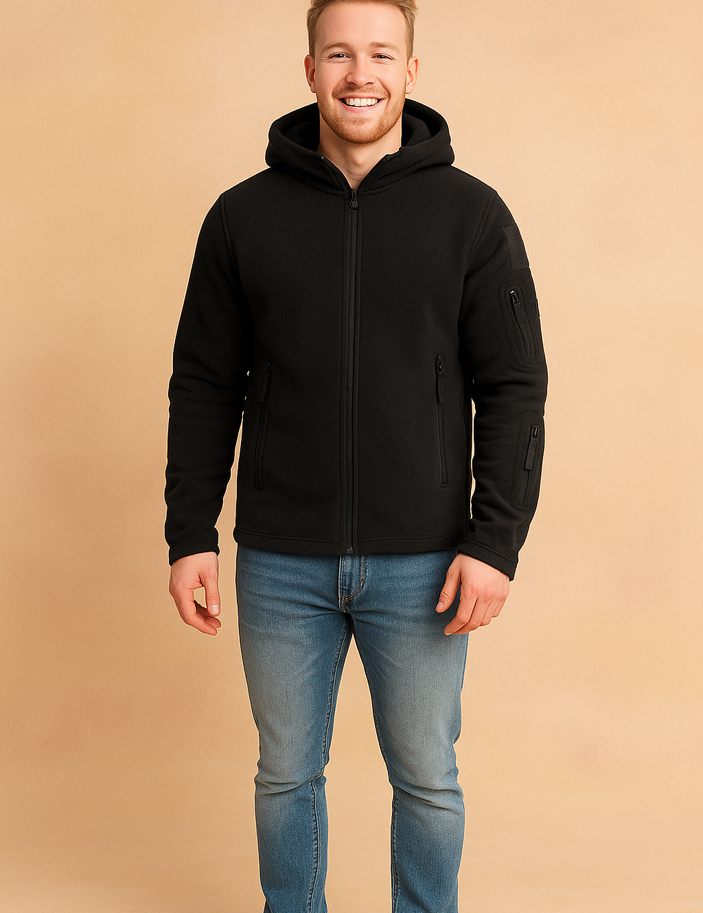 Men’s black fleece zip-up hooded jacket with multiple zip pockets and durable fabric, styled casually with jeans and sneakers