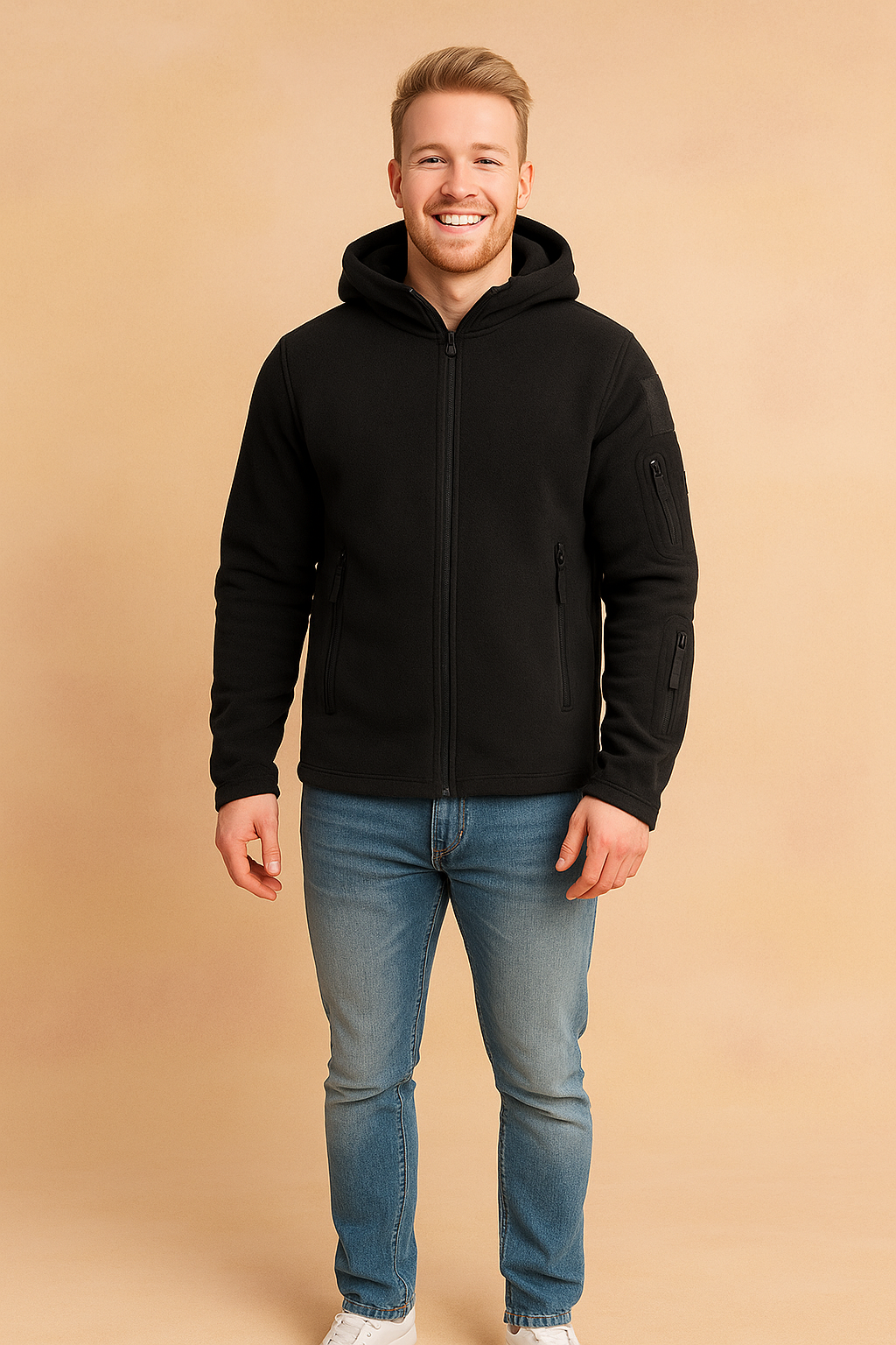 Men’s black fleece zip-up hooded jacket with multiple zip pockets and durable fabric, styled casually with jeans and sneakers