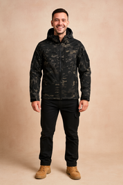 Men’s camouflage softshell jacket with multiple zippered pockets, adjustable hood, and full front zipper closure, styled for outdoor wear.
