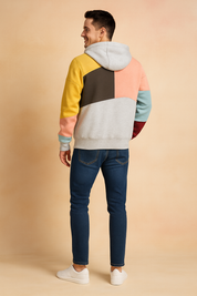 Men’s casual color-block hoodie with multicolor panel design in yellow, brown, pink, teal, red, and grey, featuring a relaxed fit, ribbed cuffs, and soft fabric texture for a trendy streetwear look.