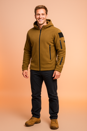 Men’s coyote brown fleece jacket with hood, full front zipper, multiple zippered utility pockets, and black fabric patch detailing