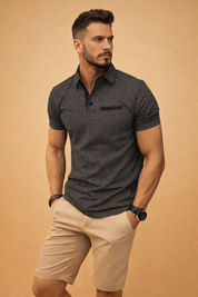 Modern short-sleeve polo top with subtle textured pattern, clean button placket, structured collar, and tailored beige knee-length shorts styled in a refined smart-casual men’s outfit.