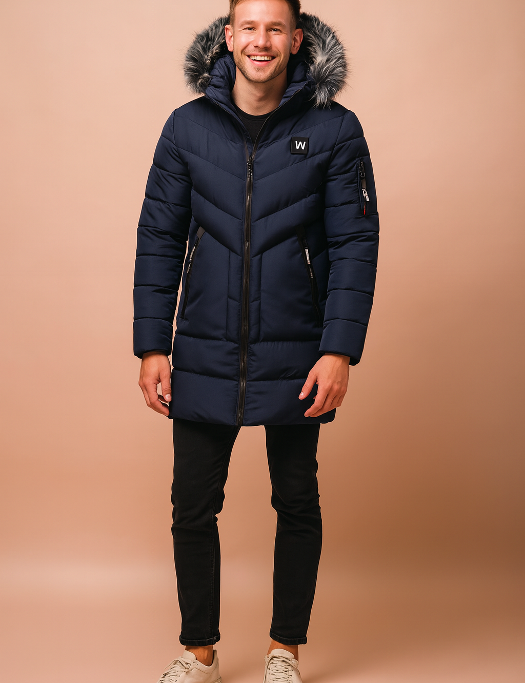 Men’s navy blue long winter parka with faux fur-trimmed hood, quilted padded design, zippered pockets, arm pocket detail, and sleek full-length zip closure for cold-weather protection.