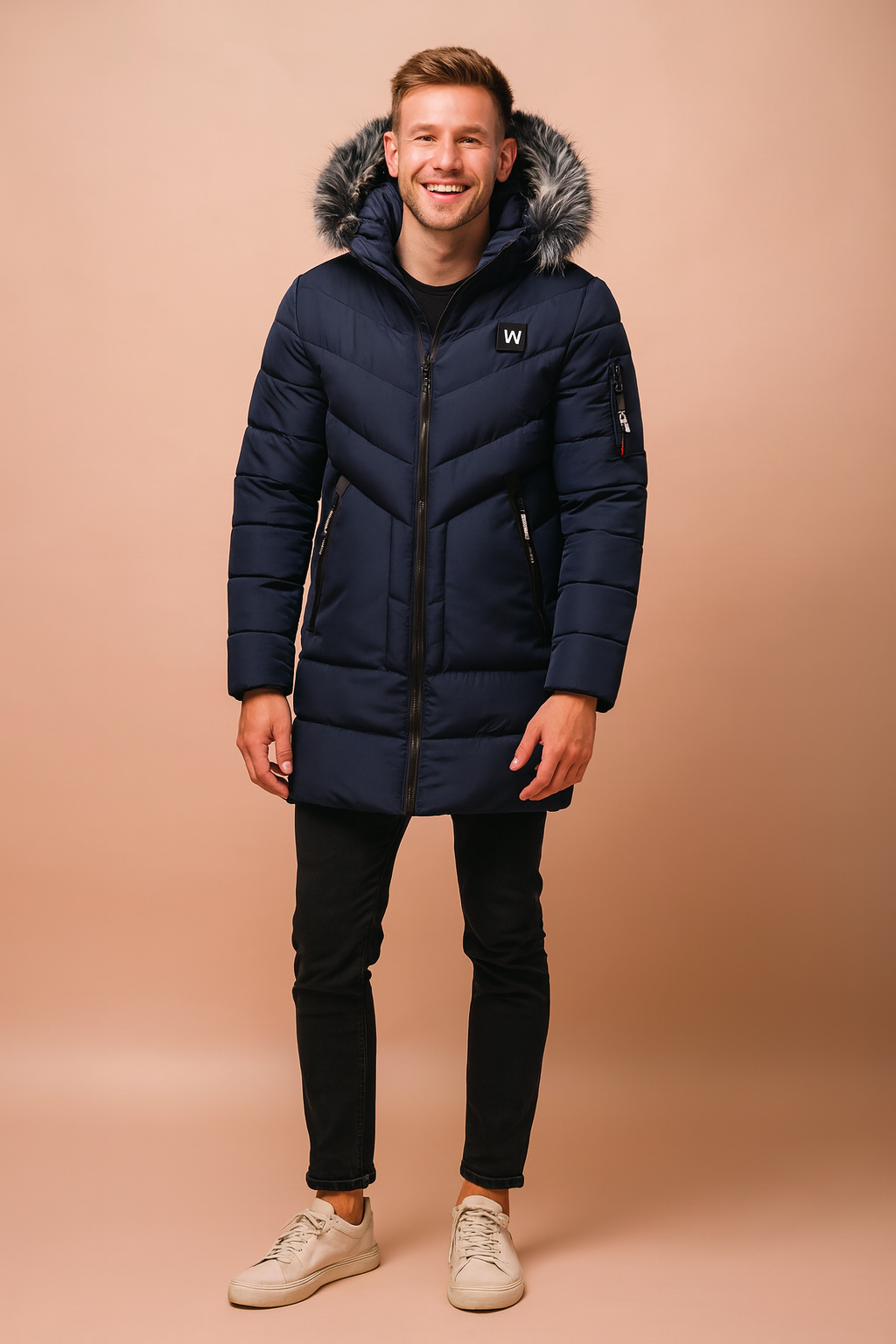 Men’s navy blue long winter parka with faux fur-trimmed hood, quilted padded design, zippered pockets, arm pocket detail, and sleek full-length zip closure for cold-weather protection.