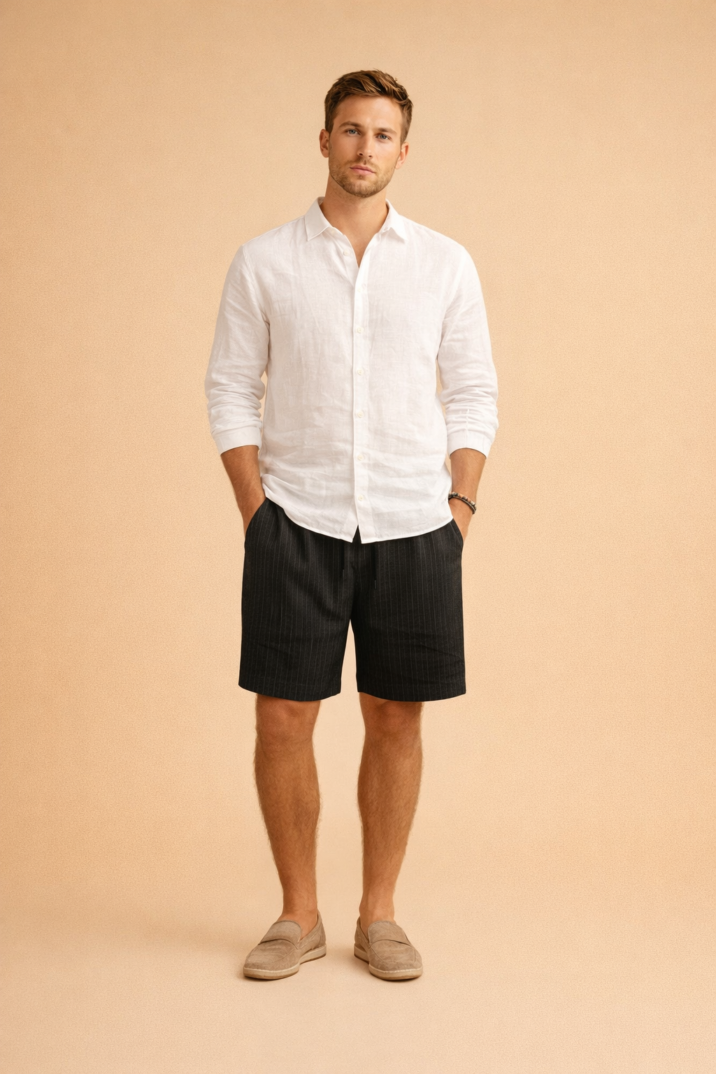 Men’s ribbed summer shorts with a clean vertical texture, tailored above-knee length, elastic waist with drawstring, styled with a crisp long-sleeve white shirt and neutral slip-on loafers for a refined casual look.