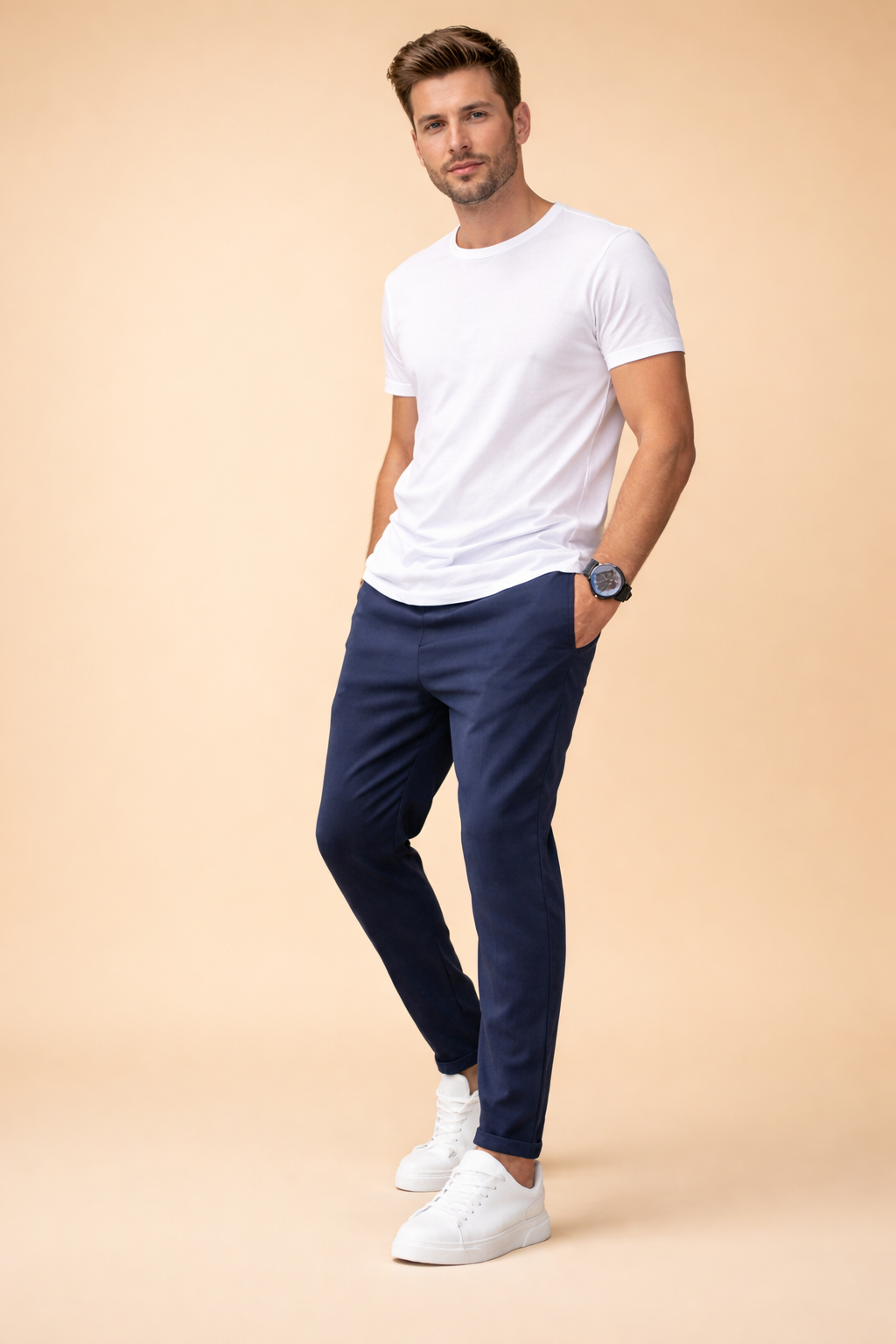 Slim-fit tapered jogger pants with elastic drawstring waist, clean front seams, ankle-length cut, and a smooth tailored drape styled with a minimalist short-sleeve crew-neck top and low-profile lace-up sneakers.