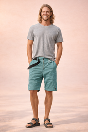 Lightweight men’s outdoor shorts in teal green with fine micro-check woven texture, breathable fabric, mid-thigh length straight cut, zip fly with single button closure, integrated black webbing belt, clean hem finish, and durable casual utility design.