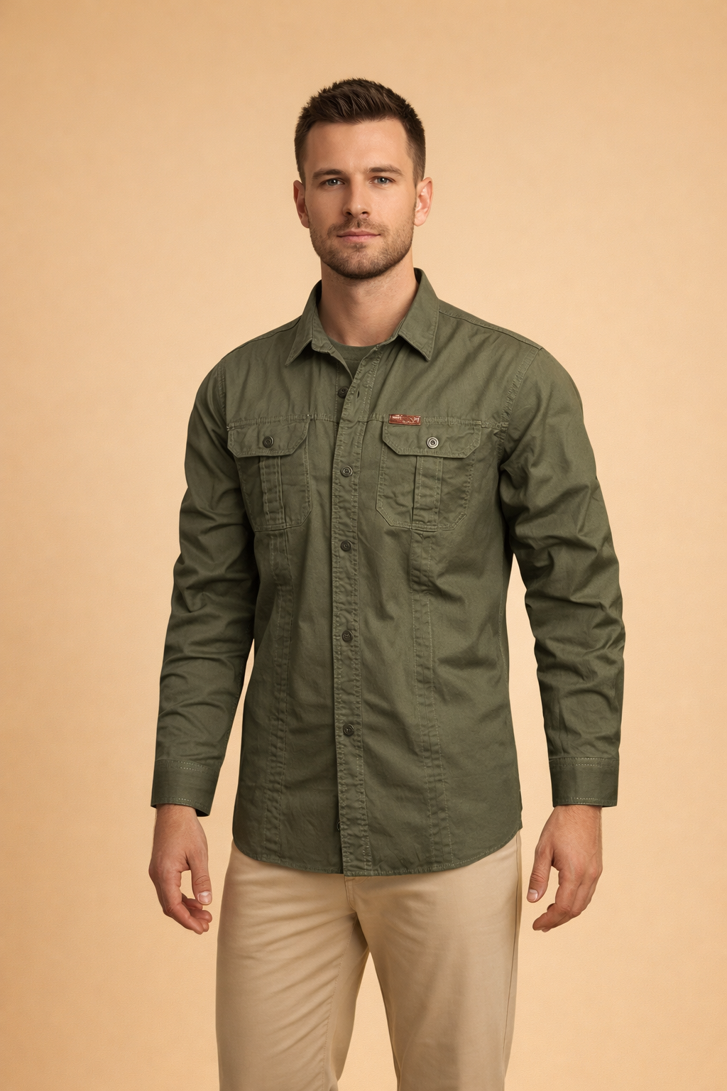 Men’s long-sleeve utility button-up shirt with structured collar, front button closure, dual chest flap pockets, and reinforced seam detailing, styled with straight-cut tailored trousers for a clean modern look.
