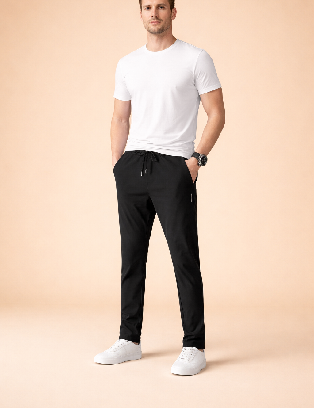 Minimalist white short-sleeve T-shirt paired with slim-fit black drawstring pants featuring a tapered leg, clean seam lines, and a smooth drape, styled with low-profile white sneakers for a modern casual look.