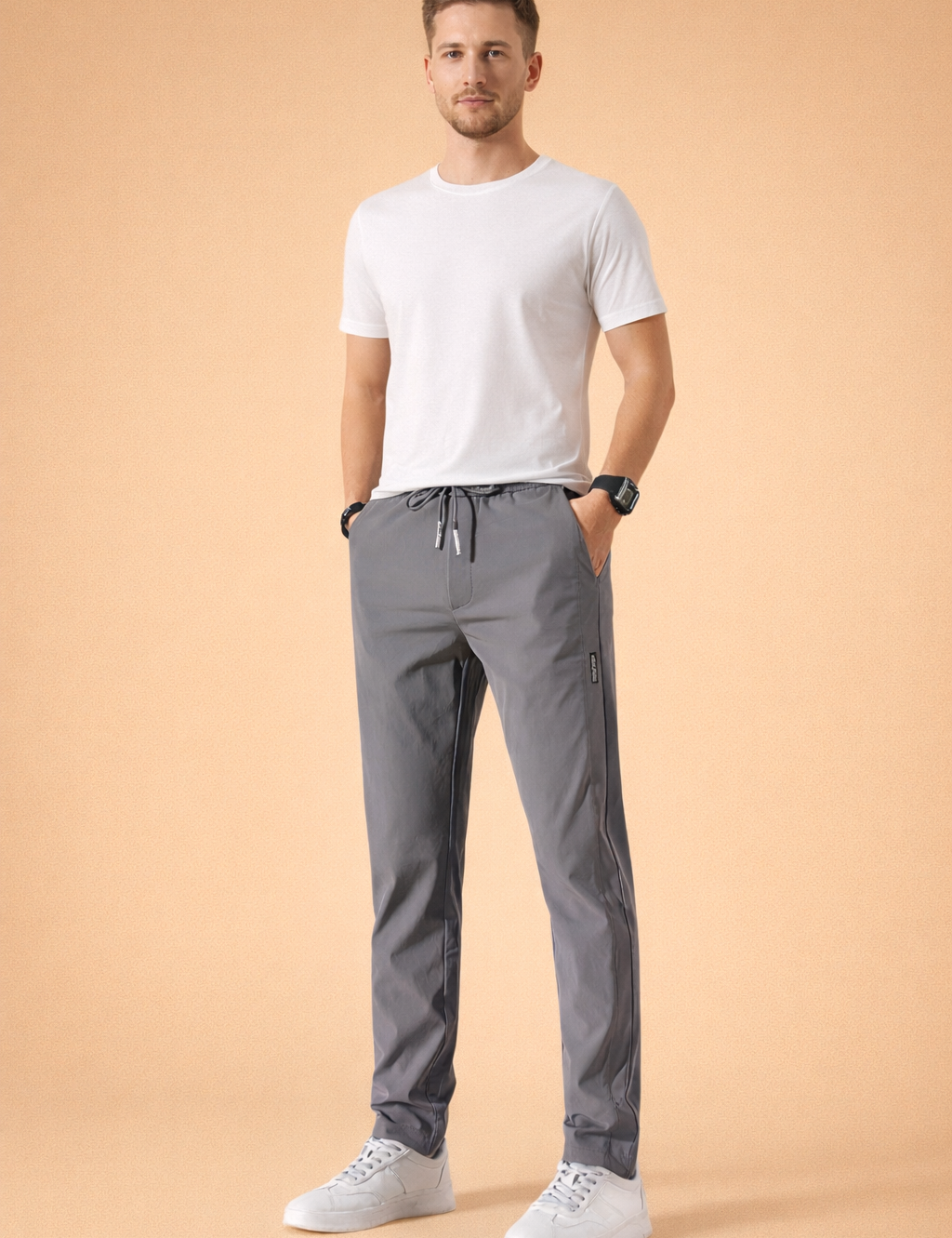 Men’s minimalist white short-sleeve t-shirt paired with straight-leg gray drawstring pants and clean white low-top sneakers, styled for a modern casual everyday look.