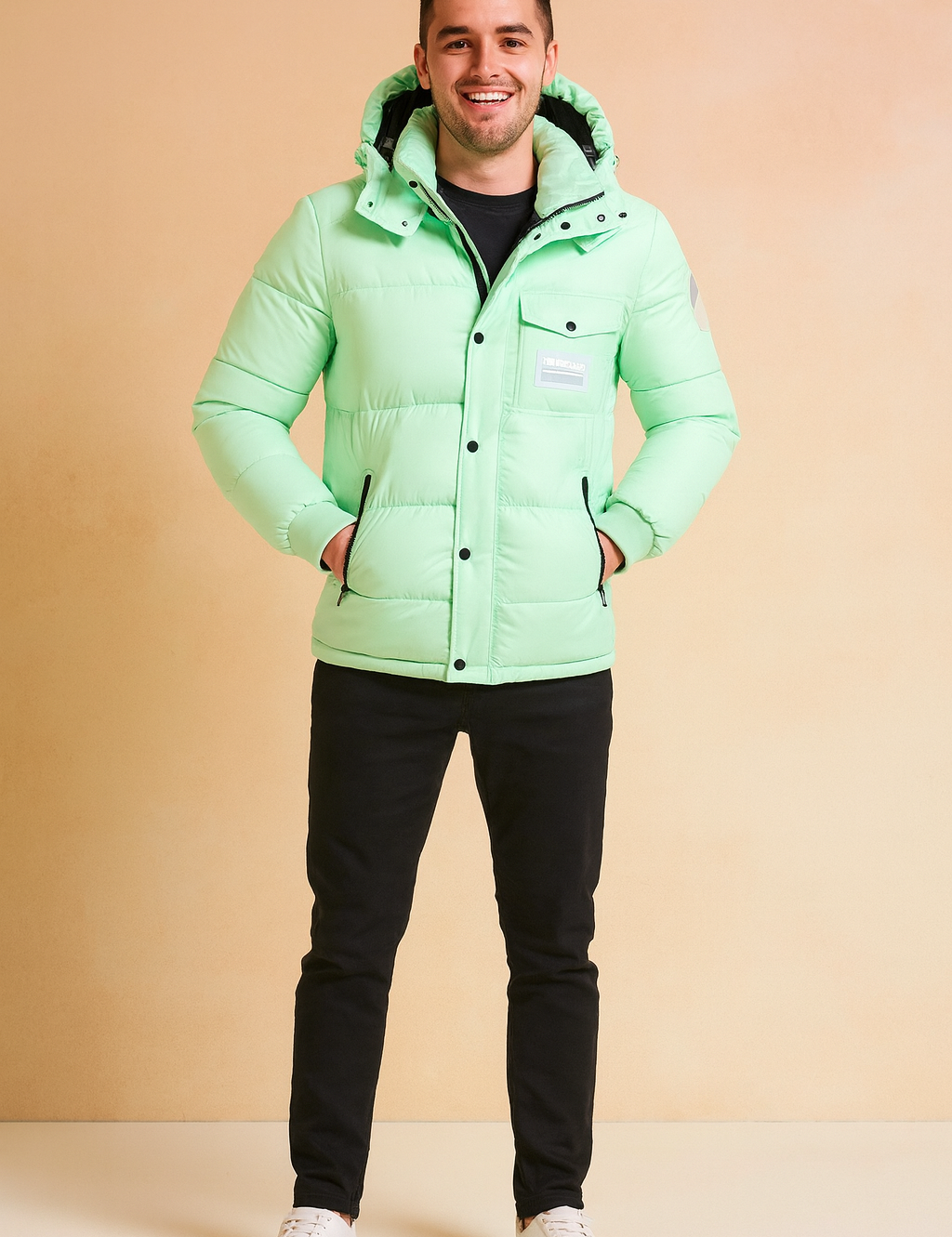 Mint green puffer jacket with hood, front snap buttons, and zippered pockets, styled with black trousers and white sneakers.