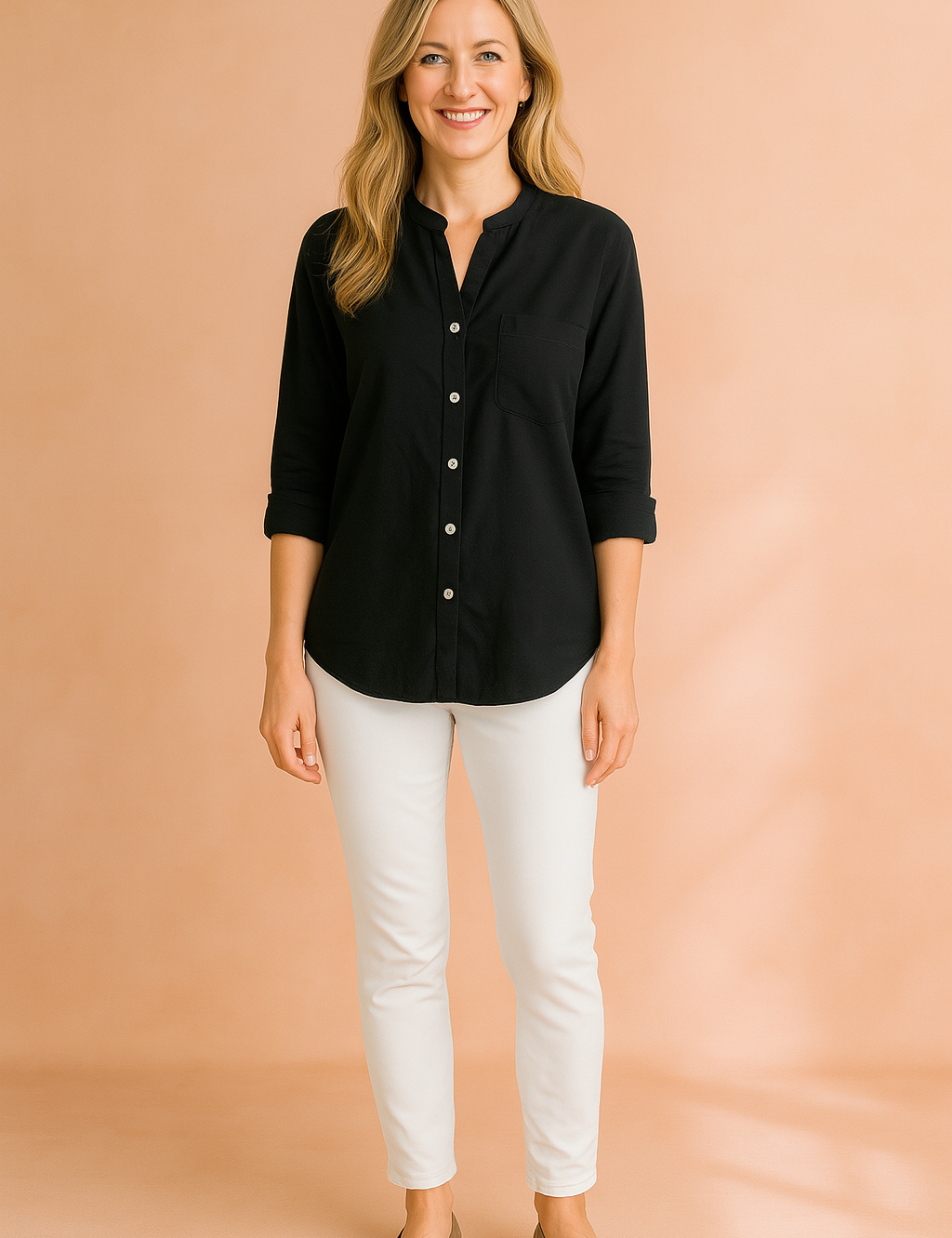 Black button-up long sleeve shirt with a single chest pocket, styled with fitted white trousers and taupe flats.