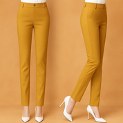 Tailored mustard yellow slim-fit trousers with belt loops and flat front closure, paired with white pointed heels and white tucked-in tops, styled for a clean, contemporary fashion look.