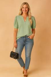 Light green embroidered puff-sleeve blouse with V-notch neckline and front seam detail, paired with mid-rise fitted blue jeans and brown espadrille wedges.