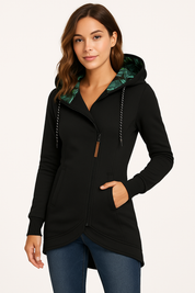 Black zip-front hoodie with tropical leaf-print hood lining, featuring a high-low curved hem, front slip pockets, ribbed cuffs, and an asymmetrical zip closure in structured cotton-blend fabric