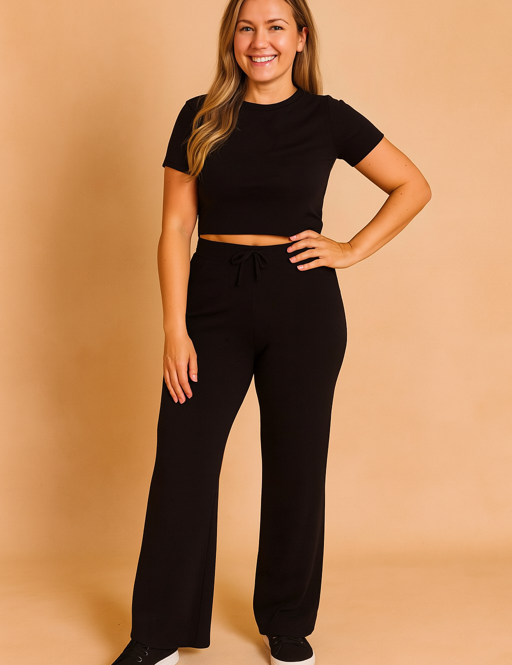 Black short-sleeve crop top paired with high-waisted wide-leg black pants featuring a drawstring waist, crafted from soft stretch knit fabric for all-day comfort.