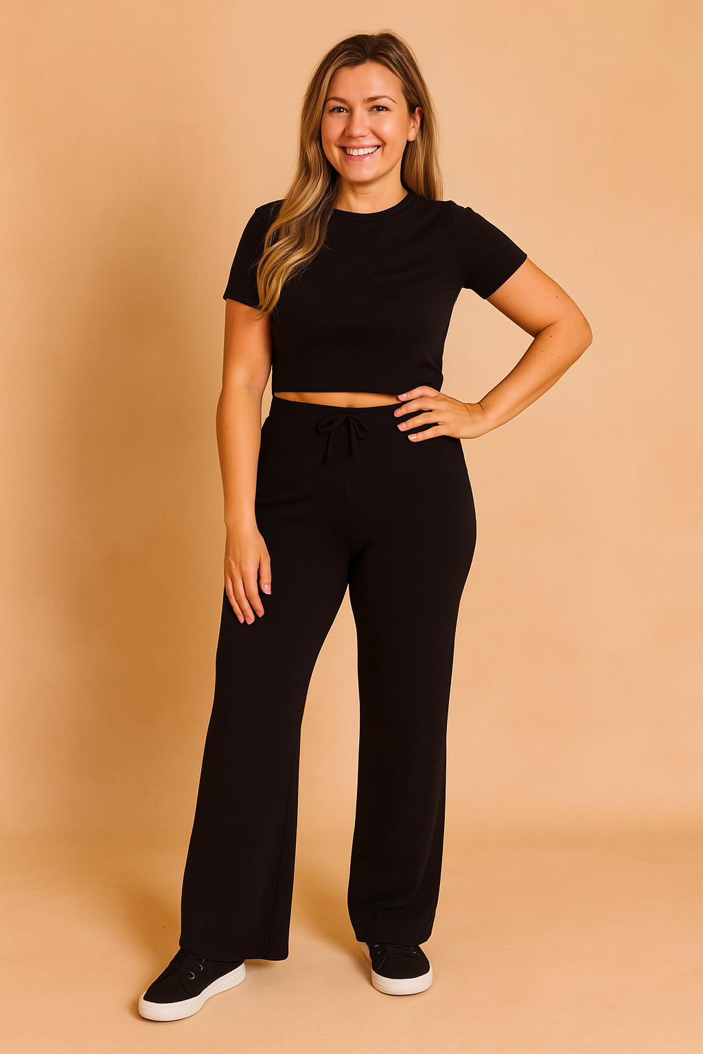 Black short-sleeve crop top paired with high-waisted wide-leg black pants featuring a drawstring waist, crafted from soft stretch knit fabric for all-day comfort.