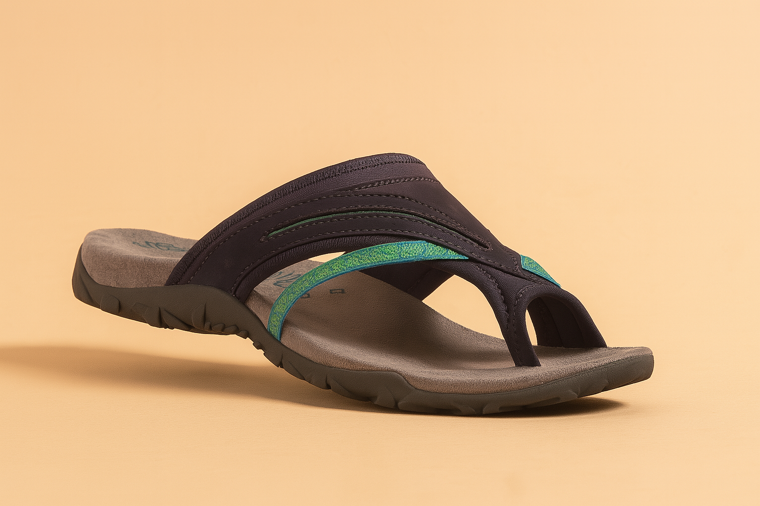Women's navy and teal thong sandals with multi-textured straps, cushioned grey footbed, and rugged rubber sole, designed for casual comfort and summer wear.