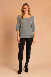 Heather gray three-quarter sleeve knit sweater with scoop neckline and ribbed cuffs, styled with black skinny jeans and suede ankle boots.