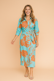 Turquoise wrap midi dress with long sleeves and a vivid orange oversized floral print, button-down front, and side tie waist.