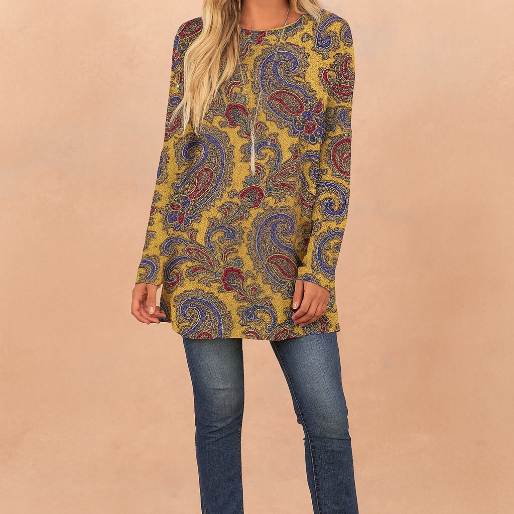 Mustard yellow paisley print long-sleeve tunic top with a relaxed fit, paired with dark blue skinny jeans and tan suede ankle boots.