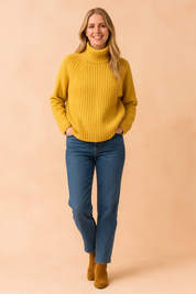 Mustard yellow ribbed turtleneck sweater paired with classic blue straight-leg jeans and tan suede ankle boots.