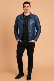 Navy blue leather jacket with quilted shoulder stitching, front zipper closure, and paired with a black t-shirt.