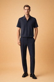 Men’s navy blue two-piece set featuring a short-sleeve collared polo shirt and matching slim-fit trousers, crafted from smooth woven fabric with a clean matte finish, straight seams, structured collar, minimalist button placket, tailored waistband, and tapered leg design for a refined modern silhouette.