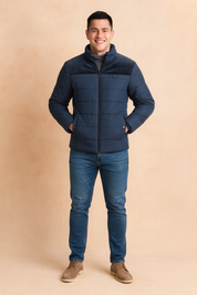 Navy blue padded jacket with textured upper panel, zip closure, side pockets, and warm inner lining, styled in a modern casual fit.