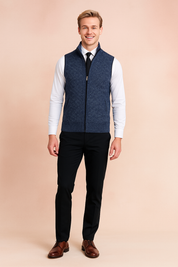 Navy blue zip-up sweater vest with subtle textured pattern, worn over a white dress shirt and black tie, paired with black dress pants.