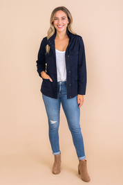 Navy casual zipper utility jacket with front flap pockets, button closure, and long sleeves styled with a white T-shirt and blue jeans.
