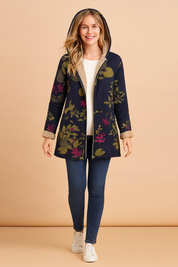 Navy floral hooded jacket with beige fleece lining, tailored fit, button-down closure, and vibrant floral print in pink, green, and yellow tones.