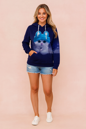 Navy blue hoodie with a large printed kitten graphic, paired with distressed light-wash denim shorts and white lace-up sneakers.