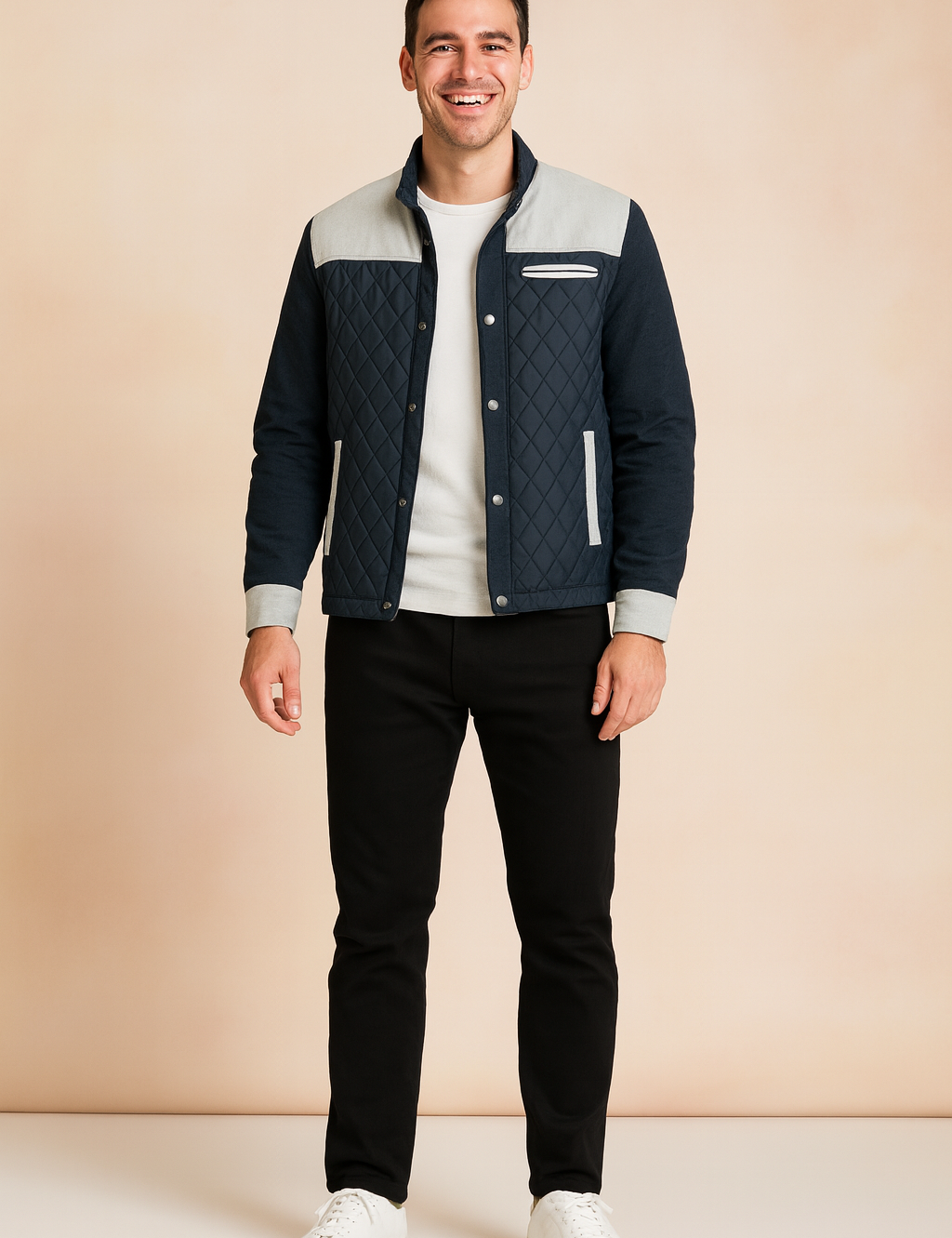 Navy blue quilted jacket with light gray shoulder panels and trim, styled with black trousers and white sneakers.