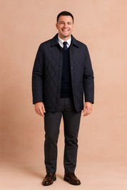 Navy blue quilted men's jacket with diamond pattern, button closure, and classic collar.