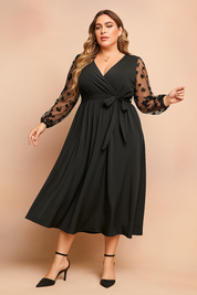 Black plus size midi dress with sheer floral long sleeves, V-neck and waist tie for women.