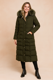 Long quilted olive green puffer coat with fur-trimmed hood, snap button closure, and side pockets, styled with black leggings and ankle boots.