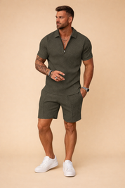 Olive green two-piece men’s summer set featuring a short-sleeve zip polo shirt and matching tailored shorts, crafted from textured fabric with a subtle geometric woven pattern, clean seams, modern athletic fit, and paired with minimalist white low-top sneakers.